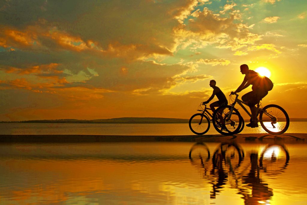 Couple biking on a beach