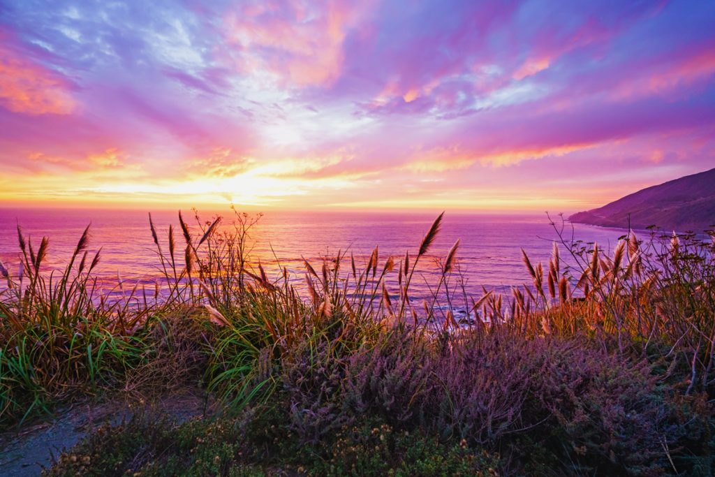 A beautiful pink sunset on the Big Sur coastline of California Central Coast.