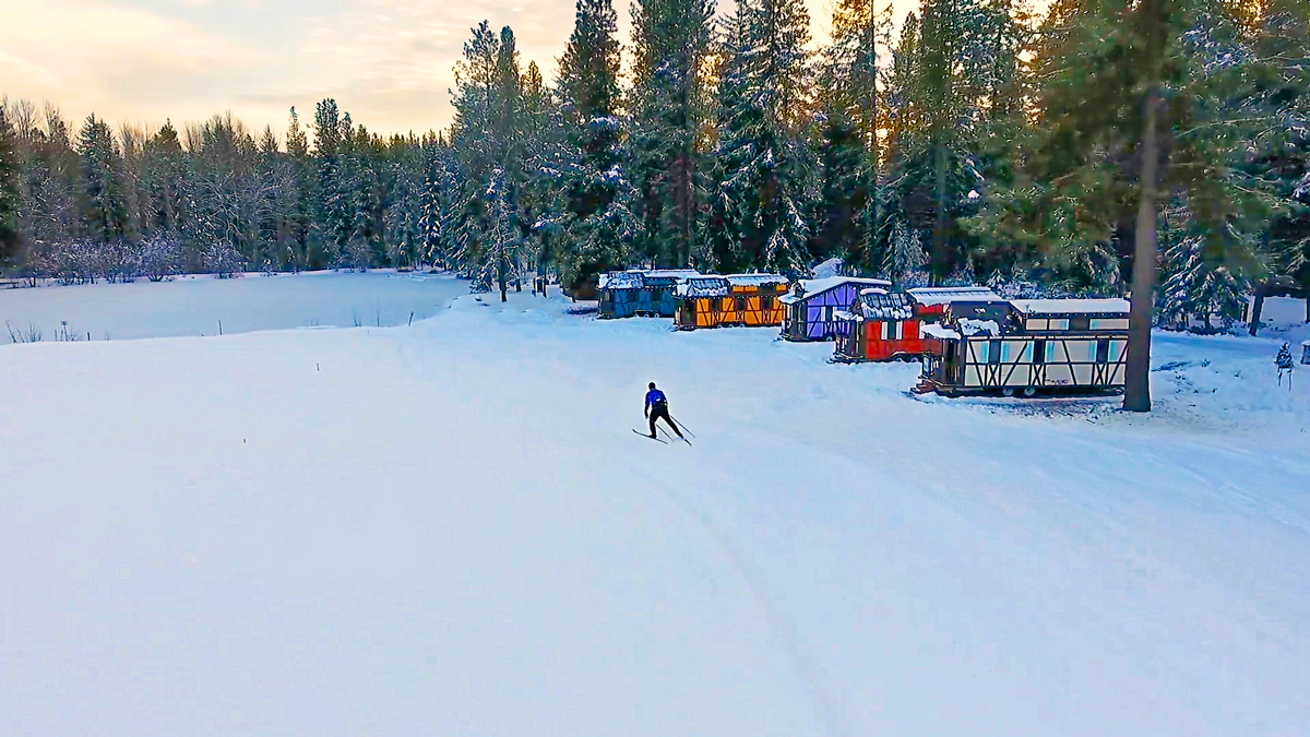 Cross-country skier skiing near the Leavenworth Tiny House Village in Leavenworth, WA